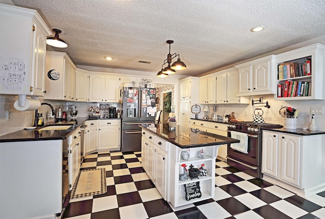 6311 Country Ln, Pine Bluff, AR 71603 - kitchen featuring open shelves, dark countertops, a sink, stainless steel appliances, and light floors