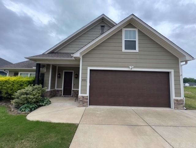 4321 Sloan, Alexander, AR 72002 - craftsman inspired home featuring concrete driveway, stone siding, and a garage