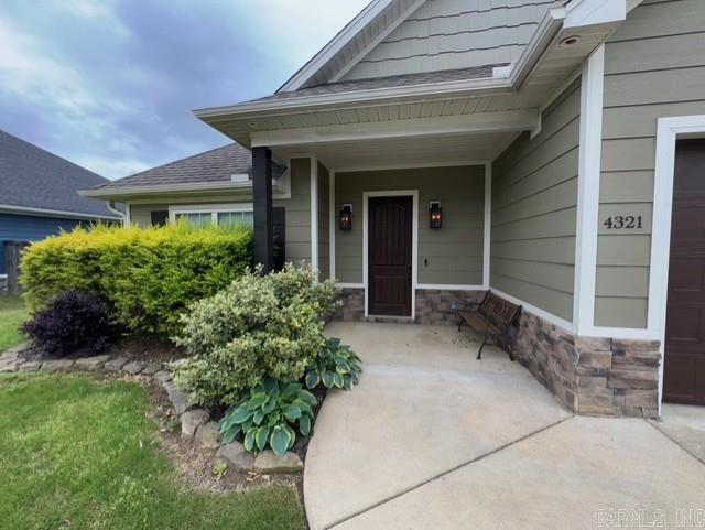 4321 Sloan, Alexander, AR 72002 - property entrance featuring covered porch and stone siding