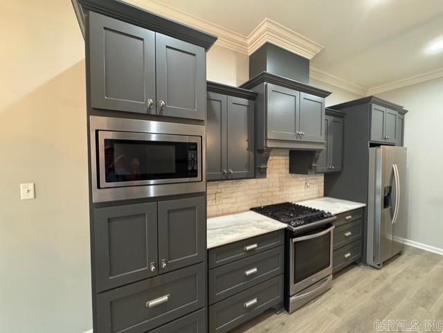 4321 Sloan, Alexander, AR 72002 - kitchen with decorative backsplash, ornamental molding, baseboards, light wood finished floors, and stainless steel appliances