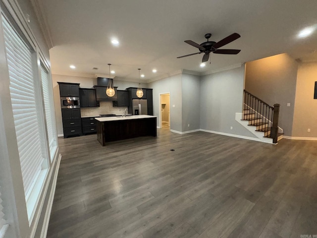 4321 Sloan, Alexander, AR 72002 - kitchen featuring appliances with stainless steel finishes, decorative backsplash, a center island with sink, and open floor plan