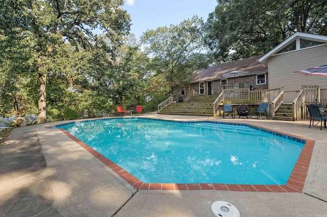 pool with a deck and stairway