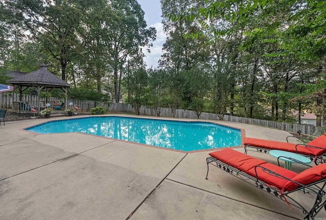 view of pool featuring a fenced backyard, a fenced in pool, a gazebo, and a patio area