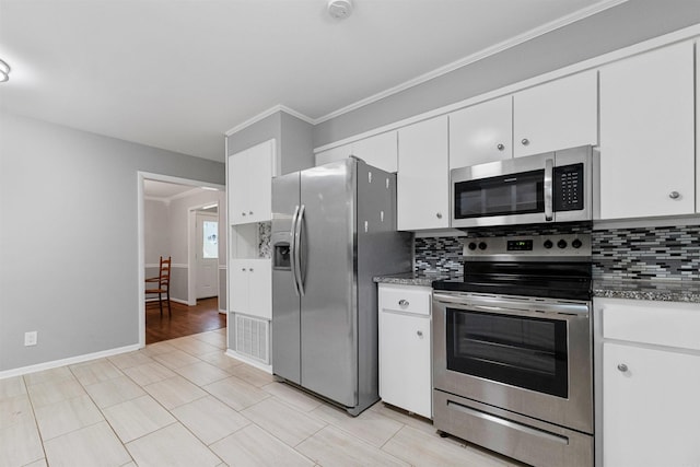 kitchen with backsplash, stainless steel appliances, white cabinetry, and visible vents