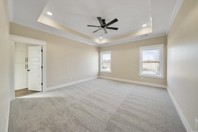carpeted empty room with a raised ceiling, baseboards, a ceiling fan, and recessed lighting