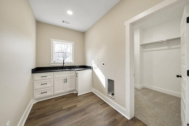 laundry room featuring a sink, baseboards, hookup for an electric dryer, visible vents, and dark wood-style floors