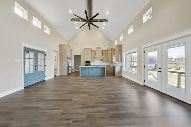 unfurnished living room featuring french doors, a ceiling fan, dark wood-type flooring, and high vaulted ceiling