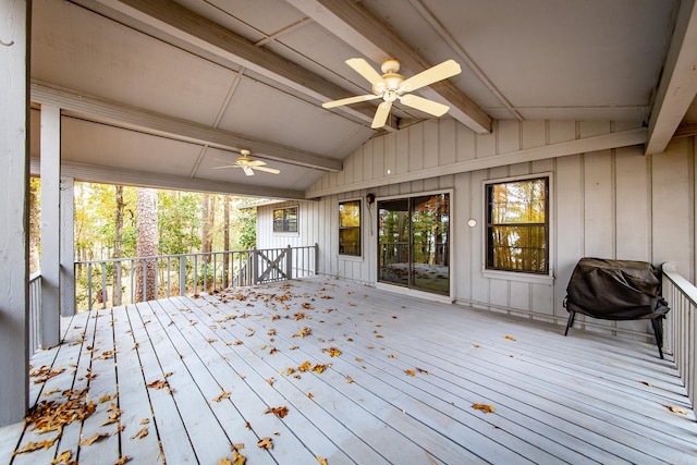 wooden deck with area for grilling and a ceiling fan