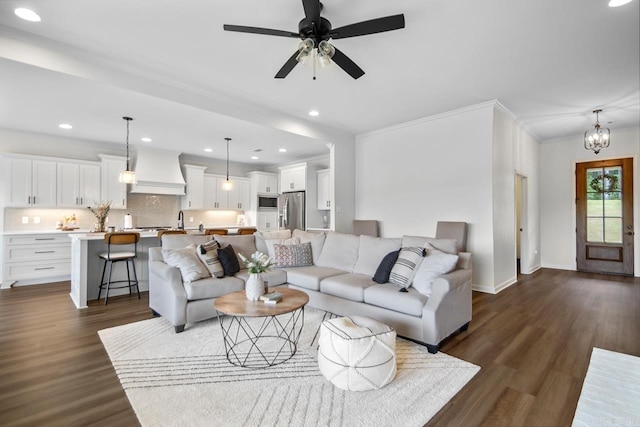 living room featuring ornamental molding, baseboards, dark wood-type flooring, recessed lighting, and a ceiling fan