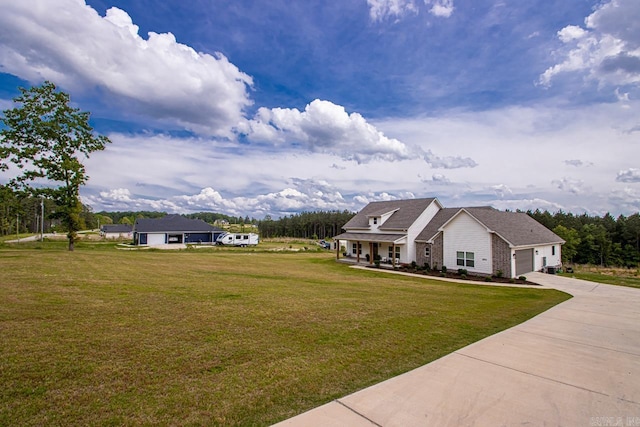 view of front of home with a porch, an attached garage, concrete driveway, and a front yard