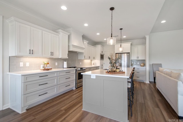 kitchen featuring dark wood-style flooring, a kitchen bar, tasteful backsplash, custom range hood, and stainless steel appliances