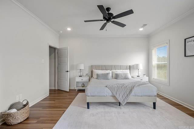 bedroom featuring visible vents, crown molding, wood finished floors, baseboards, and recessed lighting