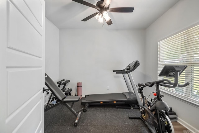 exercise area featuring ceiling fan and baseboards