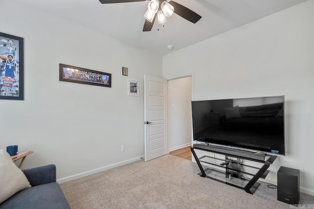 carpeted living area featuring baseboards and ceiling fan