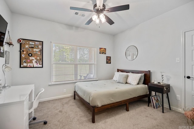 bedroom with light colored carpet, baseboards, visible vents, and ceiling fan
