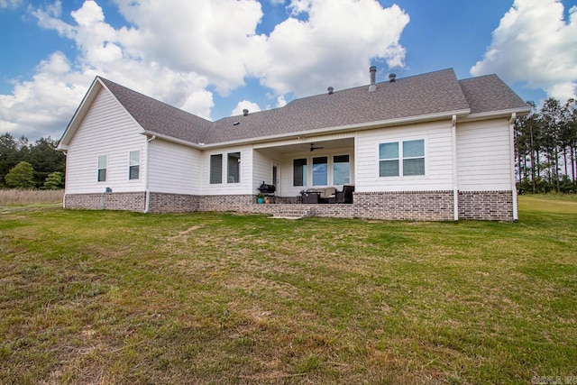 rear view of property featuring ceiling fan, a patio area, an outdoor hangout area, a yard, and a shingled roof