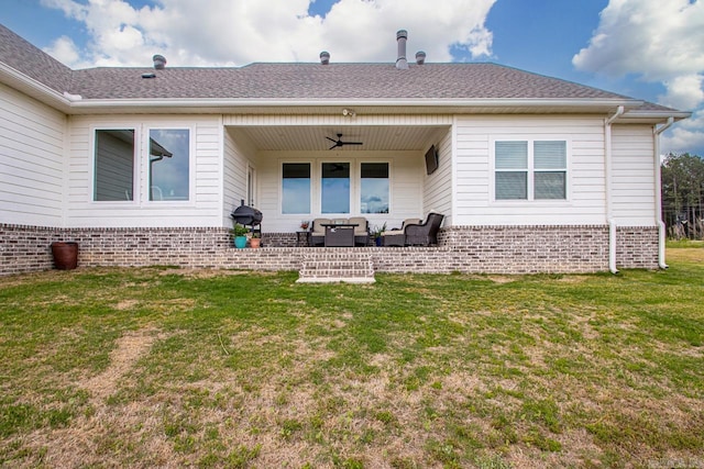 rear view of house with ceiling fan, a lawn, a patio area, brick siding, and an outdoor hangout area