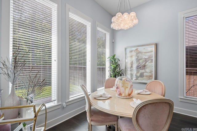 702 Wildcreek Cir, Little Rock, AR 72223 - dining room with a healthy amount of sunlight, baseboards, a notable chandelier, and dark wood-type flooring