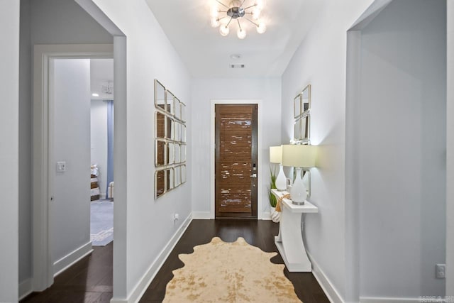 702 Wildcreek Cir, Little Rock, AR 72223 - entrance foyer featuring baseboards, visible vents, dark wood-type flooring, and a chandelier