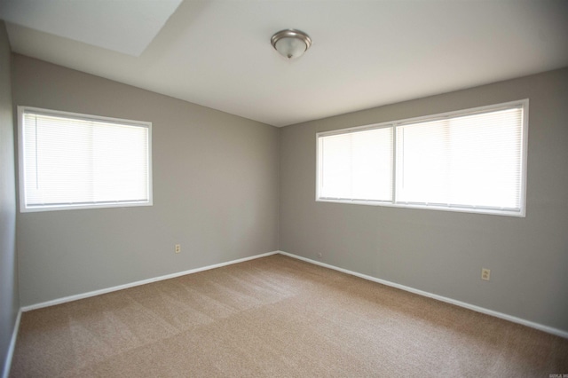 spare room with carpet floors and baseboards