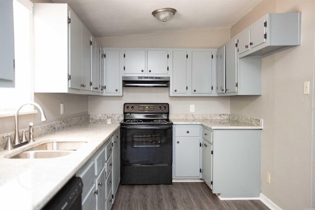 kitchen with a sink, light countertops, under cabinet range hood, dark wood-style floors, and black appliances
