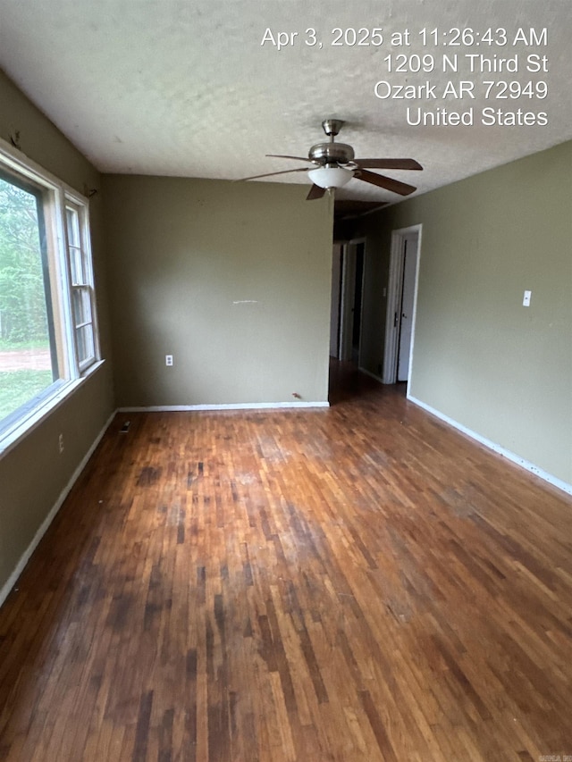 empty room featuring baseboards, ceiling fan, and hardwood / wood-style floors