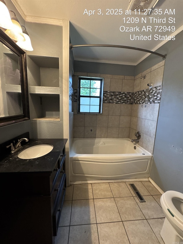 bathroom featuring tile patterned flooring, shower / bathtub combination, visible vents, and vanity