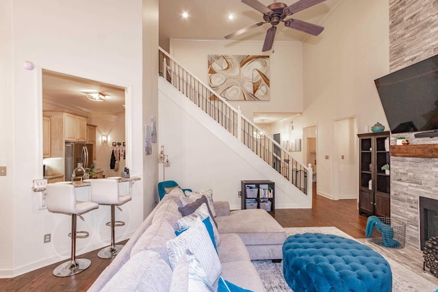 2820 Mossy Creek Dr, Little Rock, AR 72211 - living room with stairs, ceiling fan, wood finished floors, and a fireplace