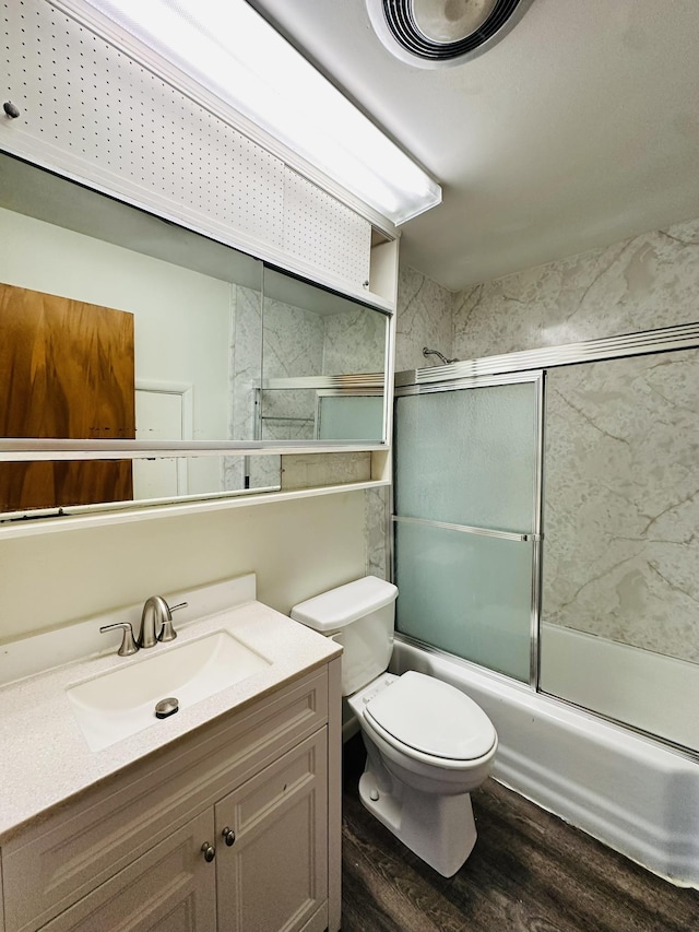 320 Church, Weiner, AR 72479 - bathroom with vanity, bath / shower combo with glass door, wood finished floors, and toilet