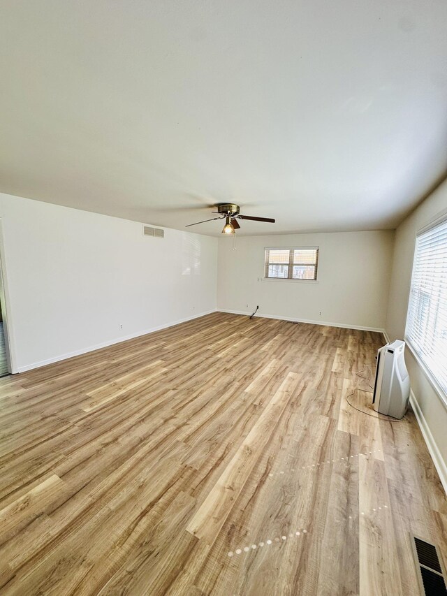 320 Church, Weiner, AR 72479 - unfurnished living room featuring visible vents, light wood-style flooring, ceiling fan, and baseboards