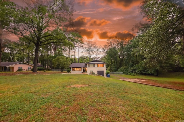 view of yard with fence and a garage