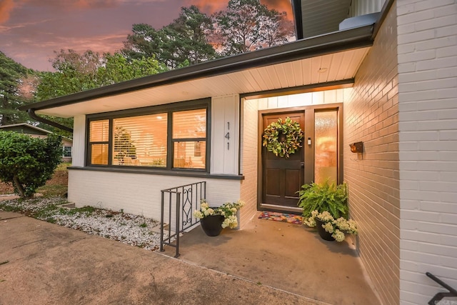 exterior entry at dusk with covered porch