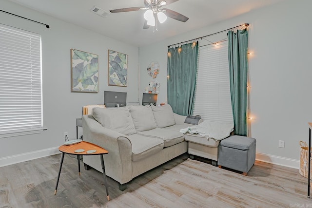 1010 Brownstone Dr, Jonesboro, AR 72404 - living area featuring baseboards, a ceiling fan, wood finished floors, and visible vents
