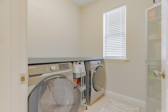 1010 Brownstone Dr, Jonesboro, AR 72404 - laundry room featuring laundry area, washing machine and dryer, baseboards, and tile patterned flooring