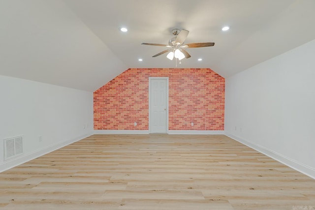 1010 Brownstone Dr, Jonesboro, AR 72404 - bonus room featuring ceiling fan, brick wall, visible vents, vaulted ceiling, and light wood finished floors