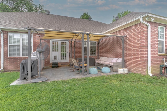 1010 Brownstone Dr, Jonesboro, AR 72404 - back of property with a lawn, a shingled roof, outdoor lounge area, and brick siding