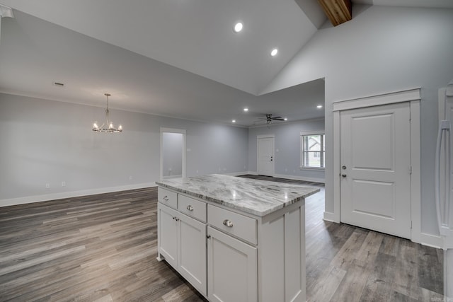 kitchen with light wood-style floors, open floor plan, white cabinetry, and light stone countertops