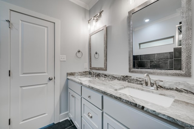 bathroom featuring double vanity, ornamental molding, and a sink