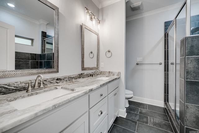 bathroom featuring crown molding, a shower stall, and a sink