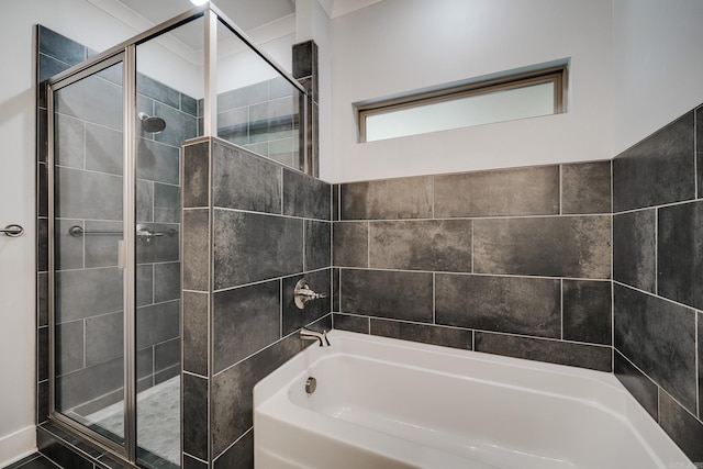 full bath featuring tiled shower and a tub to relax in