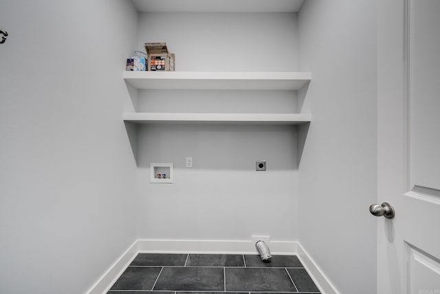 laundry area with washer hookup, laundry area, baseboards, dark tile patterned flooring, and hookup for an electric dryer