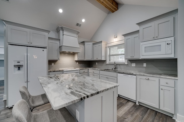 kitchen with visible vents, dark wood-style flooring, white appliances, custom range hood, and a sink