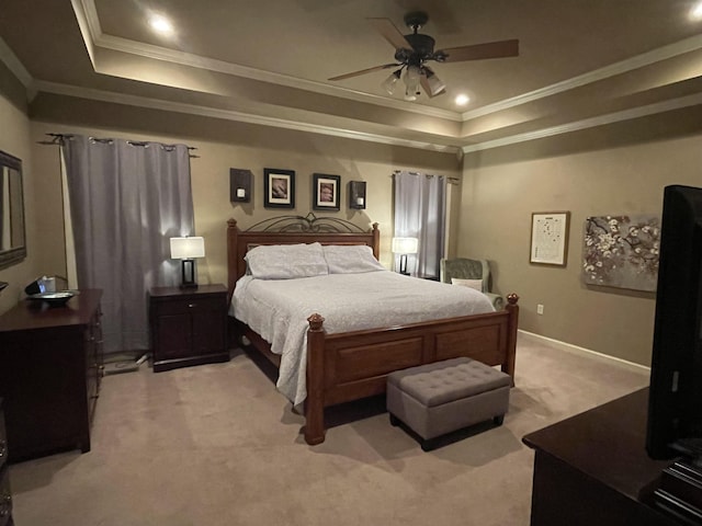 bedroom with ceiling fan, light colored carpet, a raised ceiling, baseboards, and ornamental molding