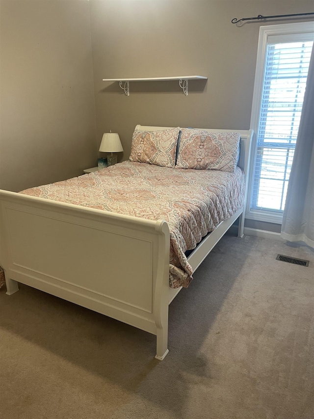 bedroom featuring carpet floors, baseboards, and visible vents