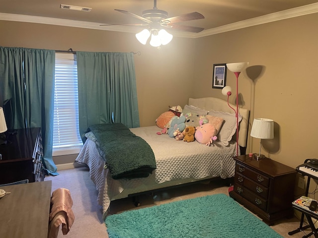 bedroom with ornamental molding, carpet, a ceiling fan, and visible vents