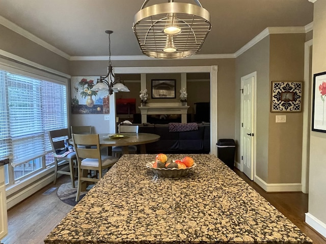 dining room featuring baseboards, ornamental molding, a fireplace, and dark wood-type flooring