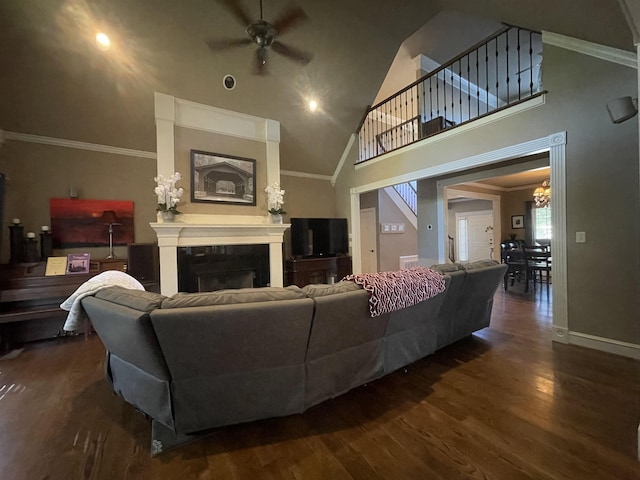 living area featuring high vaulted ceiling, dark wood-style floors, ceiling fan with notable chandelier, and a fireplace