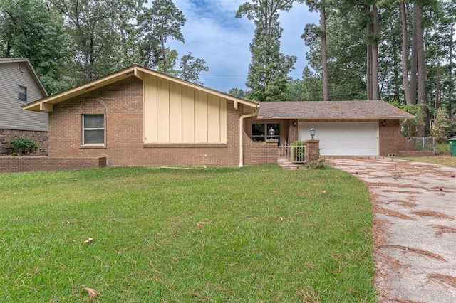 single story home with an attached garage, a front lawn, brick siding, board and batten siding, and concrete driveway
