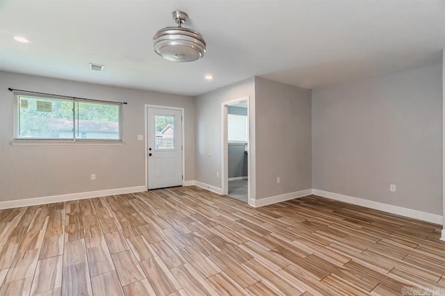 interior space featuring recessed lighting, baseboards, light wood finished floors, and visible vents