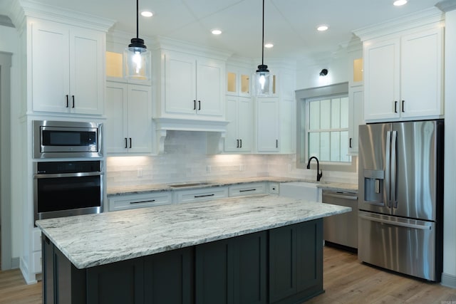 100 Laurie Dr, Mena, AR 71953 - kitchen featuring a center island, white cabinetry, tasteful backsplash, and stainless steel appliances
